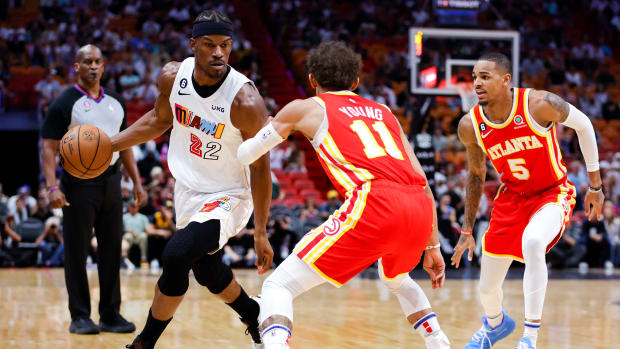 Hawks guards Trae Young and Dejounte Murray defend Heat forward Jimmy Butler.